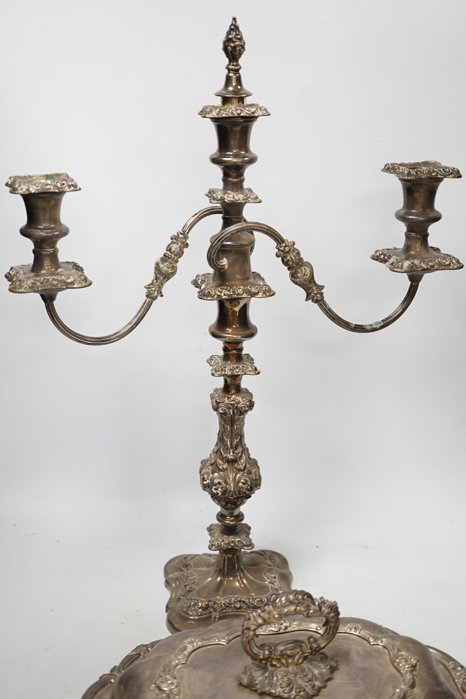A silver plated entree dish and cover and a pair of three light candelabra, tallest 55cm
